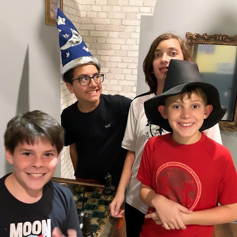 Future Wizards saving the 'Magic School' puzzle at EDGE Escape Room, a must-visit escape room in Kissimmee for thrill-seekers