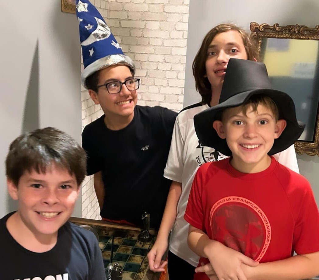 Future Wizards saving the 'Magic School' puzzle at EDGE Escape Room, a must-visit escape room in Kissimmee for thrill-seekers